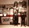 Geddy and Alex in front of their mural at the Rock Hall