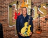 Alex Lifeson holding Gibson Gives Guitar for Peace for Ukraine - juliensauctions.com